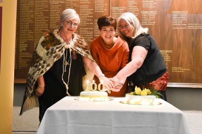 Image of Dame Patsy helping to cut the cake