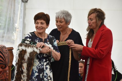 Image of Yvette Grace, General Manager, Rangitāne Tū Mai Rā Trust and Tina Te Tau– Brightwell, Pūkaha Board of Trustees helping Dame Patsy take off the korowai