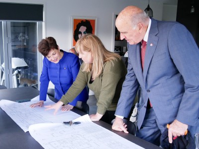 Image of Dame Patsy, Sir David and Julie Chapman looking at architect's plans