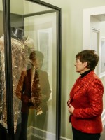 Image of Dame Patsy examining Te Mahutonga, the kakahu worn by our Olympic flag bearer at opening ceremonies