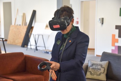 Image of Dame Patsy trying out a VR game