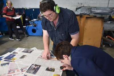Image of Dame Patsy examining a newspaper