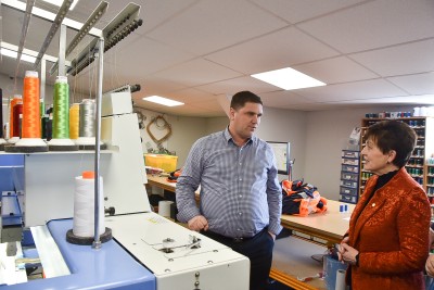 Image of Dame Patsy and Mark Simpkin with one of the embroidery machines