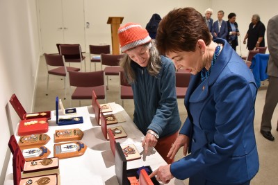 Image of Dame Patsy looking at the various insignia and pieces of Governor-General memorabilia