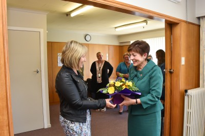 Robyn Morris presenting Dame Patsy with flowers