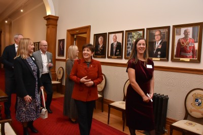 Dame Patsy and Te Papa Foundation guests with the Government House portraits of previous Governors-General