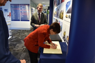 Image of Dame Patsy signing the Visitor Book at the Australian Antarctic Division