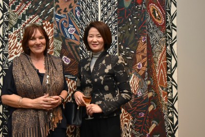 Two guests standing in front of an artwork