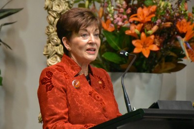 Dame Patsy speaks at a lectern