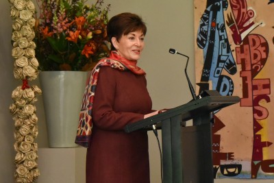 Dame Patsy speaks at a lectern