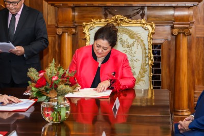 Dame Cindy signing the warrant