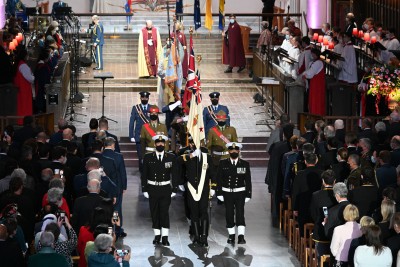 Members of the NZDF parade the Queen's Colours out of the Cathedral