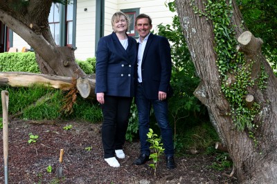 Ann Foster and Andy Foster next to Ann's camelia 