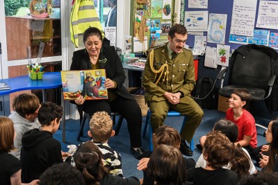 Dame Cindy and aide-de-camp Capt. Josh Kyle read the students a story
