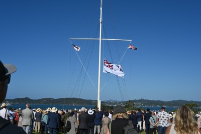 The crowd watching the White Ensign being lowered
