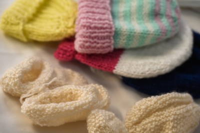 Some home-knitted items of clothing for newborns in the maternity annex