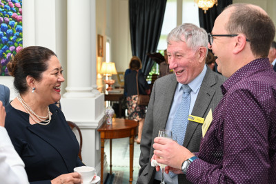 Dame Cindy in conversation with two attending volunteers