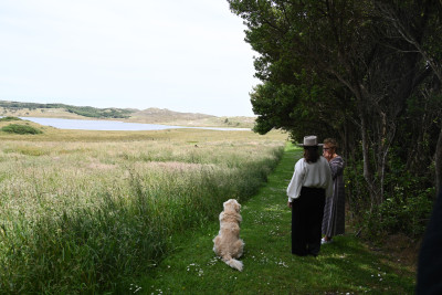 Dame Cindy and Lois Croon overlooking a meadow and lake at Admiral Garden