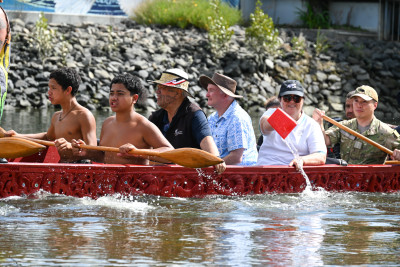 Dame Cindy taking her turn at bailing water from the waka