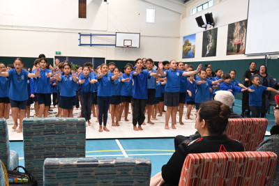 Dame Cindy watching a performance by the tamariki of Te Kura o Te Paroa