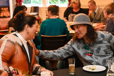 Dame Cindy meeting one of the guests for the celebratory high tea