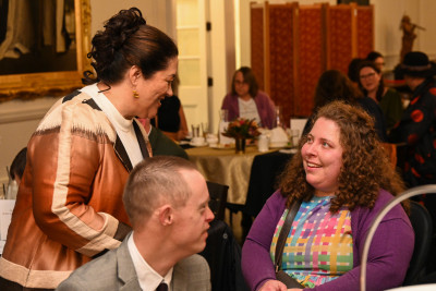 Dame Cindy meeting one of the guests for the celebratory high tea