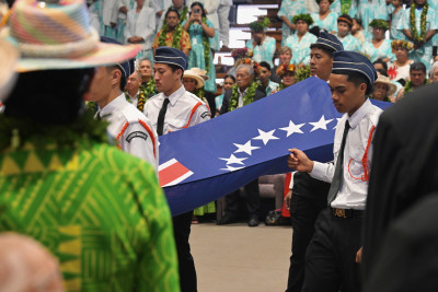 The Cook Islands flag being carried forward for the official flag-raising