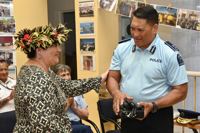 Dame Cindy presenting the radios to Cook Islands Police Commissioner Teokotai Joseph