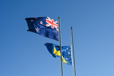 The New Zealand and Tokelauan flags raised