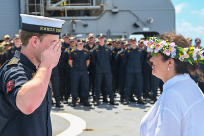 Dame Cindy saluted by a member of the ship's company