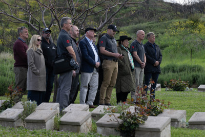 Dame Cindy, Dr Davies and the official party sing a waiata at the No. 2 Outpost Cemetery
