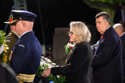 Dame Helen carries her wreath to be placed