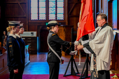 Members of the New Zealand Cadet Forces present the Ensign to The Reverend Lance Lukin