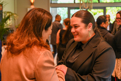 Dame Cindy speaks with a guest