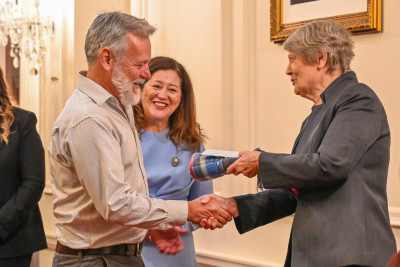 Dame Cindy and Helen Clark present Dr Gordon Macdonald with a gift