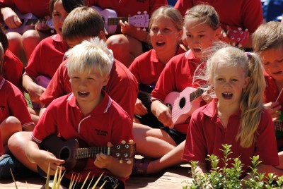 Five Forks School children perform "Leaving on a Jet Plane" for The Governor-General.