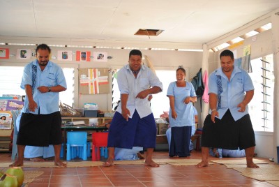 Teaching staff perform a song/dance for the Governor-General.