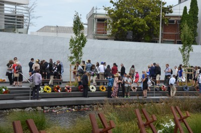 Examining the wall, where 185 people's names are inscribed.