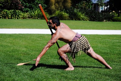 A member of the New Zealand Defence Force Cultural Group offers a dart to the manuhiri.