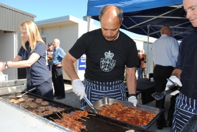 The Governor-General cooks for the Habitat for Humanity volunteers.