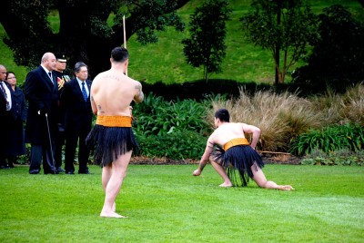 A member of the Māori Welcoming Party places the rakau tapu (dart) at the feet of the King.