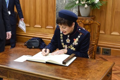 Dame Patsy Reddy signs the Visitors' Book at Parliament.